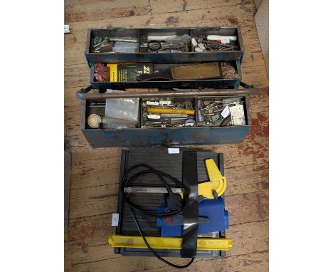 A electric ceramic tile cutter with toolbox and contents, shipping unavailable