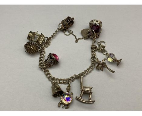 A silver 925 charm bracelet with white metal charms