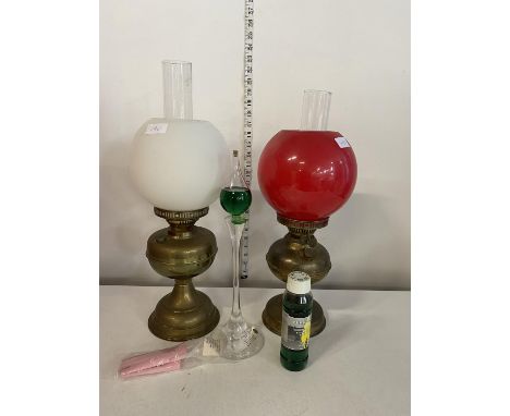 Two vintage brass and glass oil lamps with a modern candleholder, shipping unavailable