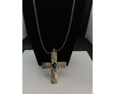 A large white metal crucifix on chain stamped 'DS Made in Denmark'