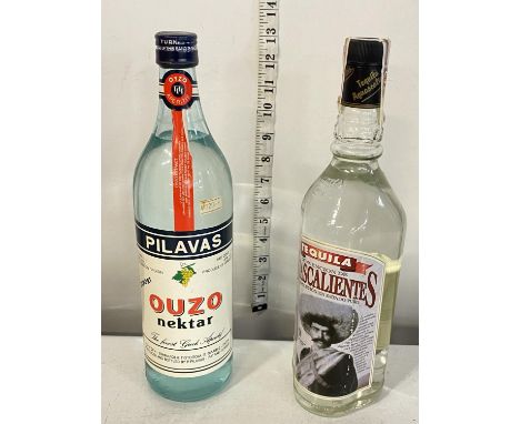 A bottle of tequila 1L with a 1L bottle of Ouzo
