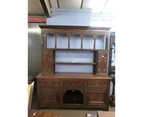 Large Victorian gothic revival heavily carved oak dresser with two shelf back, two small integral side doors over a base with