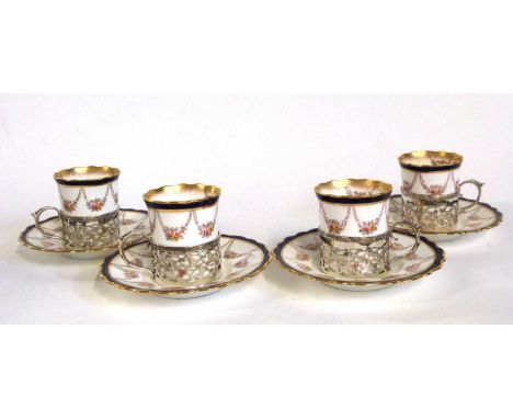 A group of four Aynsley coffee cups and saucers, the cups in silver mounts, assay marks for Birmingham