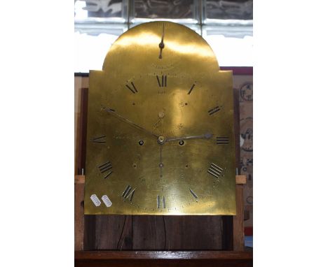 Saddleton, Lynn - A Georgian long case clock with arched brass dial and an eight day movement, set in an oak case with arched