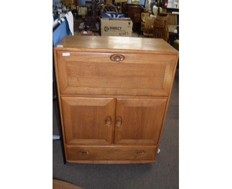 Ercol light elm drinks cabinet with drop down front over a drawer and cupboard base