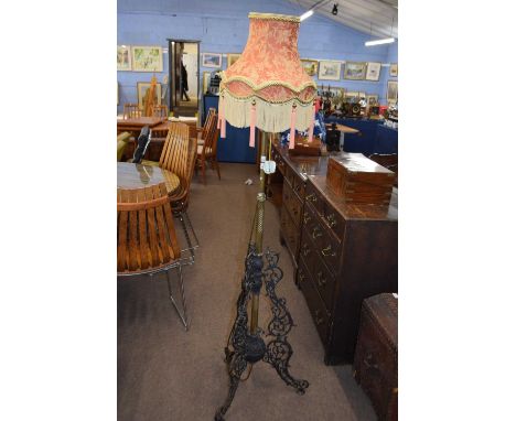 Late 19th Century iron and brass standard lamp with frilled shade, approx 170cm high