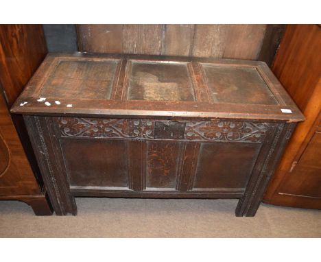An 18th Century oak coffer with hinged panel lid over a base with three panelled front and panelled sides and back, 114cm wid