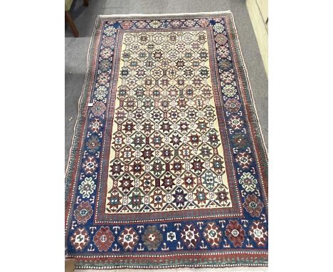 Persian wool rug with multi star design to central panel 140 x 225 cm