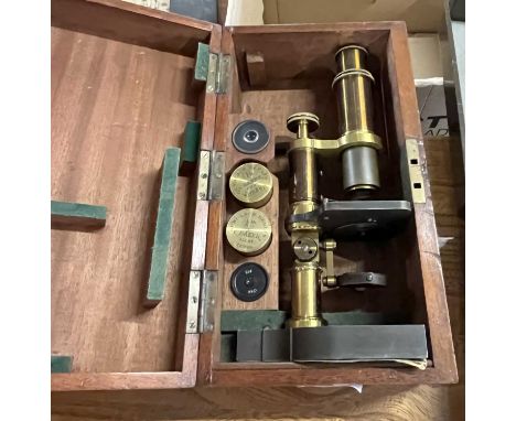 Baker - A brass and Steel cased monocular microscope set in hardwood case