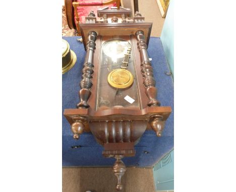 Late 19th Century wall clock, the white enamel dial with Roman numerals, carved in turned wooden case
