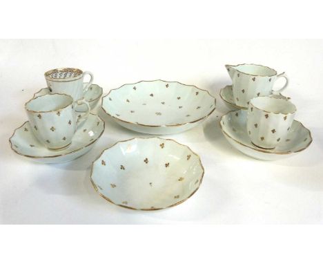 A late 18th Century Lowestoft porcelain part tea set comprising two coffee cups with unusual shape handles, four saucers, sid