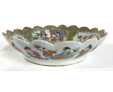 A 19th Century Cantonese porcelain bowl with fluted rim decorated in typical fashion with panels of Chinese figures and birds