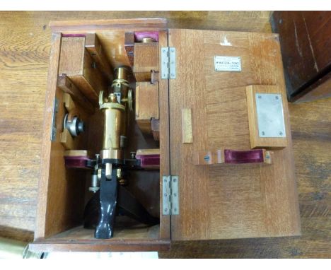 A lacquered brass and steel monocular microscope signed E.Leitz Wetzlar 808922, approx 30cm high, set in a wooden case bearin