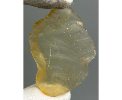 A NEOLITHIC SCRAPING TOOL IN DESERT GLASS TEKTITE, From the Tenerean Culture, tool was worked circa 5,000 years ago. Fashione