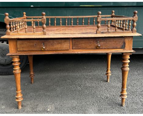 AN INDIAN DESK WITH GALLERIED TOP AND TWO SLIDING DRAWERS