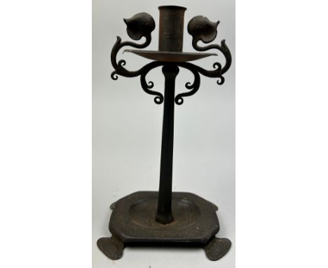IN THE MANNER OF LIBERTY AND CO, an arts and crafts wrought iron candle stick. 