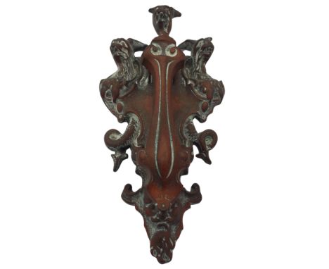 A Victorian brass door knocker, cast with hell hound Cerberus above Hades face mask, height 30cm.