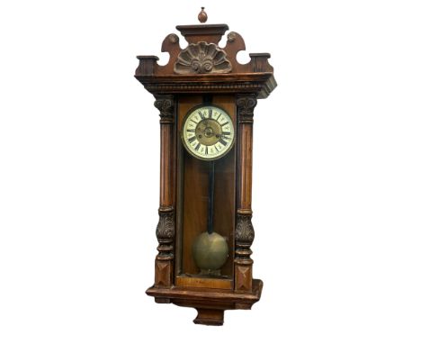A Vienna wall clock, walnut and ebonised case with enamel chapter ring, height 110cm x 42cm.