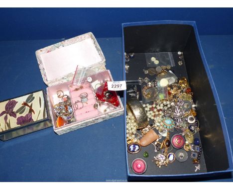 A quantity of costume jewellery including bangle, clip on earrings, brooches etc pus two small jewellery boxes.