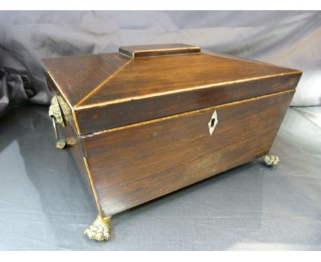 A Regency sarcophagus form tea caddy, on brass paw feet