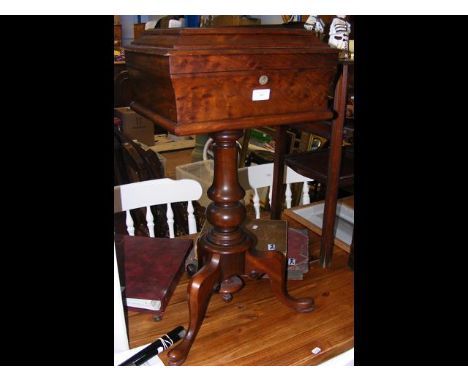 A 19th century tea poy CONDITION REPORTSplits in veneer to top. No lock. One interior caddy. See image for interior.