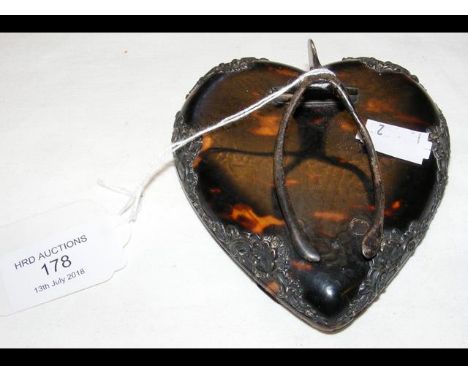 A silver and tortoiseshell letter clip in the form of a heart and wishbone 