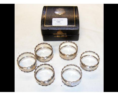 A cased set of six silver napkin rings 