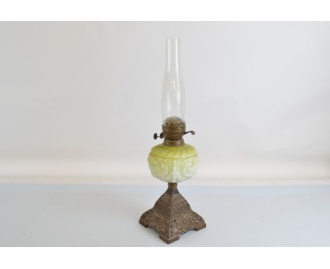 An early 20th century oil lamp, cast metal base stamped FS&amp;Co. Ltd. Reg No. 294312. 56cm tall.