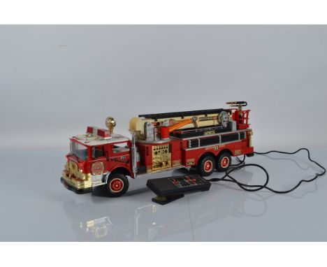 A 1990 battery operated New Bright fire Engine, 68cm long.