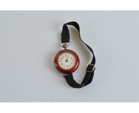 A Continental white metal and enamel ladies trench watch, with white enamel dial and Arabic numerals, the reverse with painte