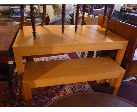 A Contemporary light oak dining table and two matching benches