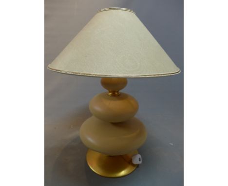 A mid 20th Century three tiered ochre ceramic table lamp, on conical base, H:73cm