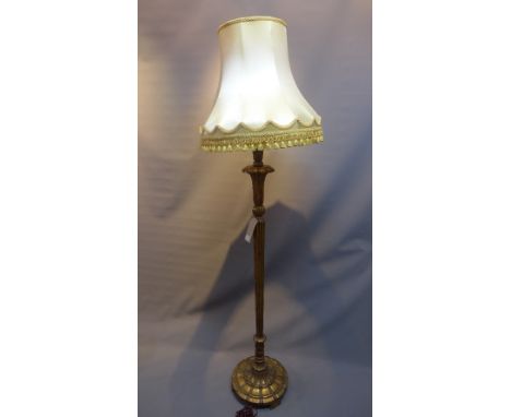 A 1920's giltwood standard lamp with reeded column raised on scalloped base, (with sahde)