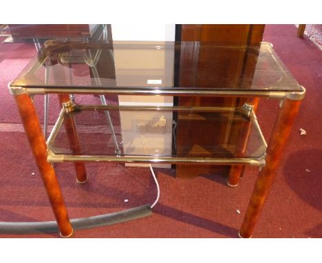 A 1970's brass two tier console table with wood effect legs, H:74cm W:82cm D:37cm