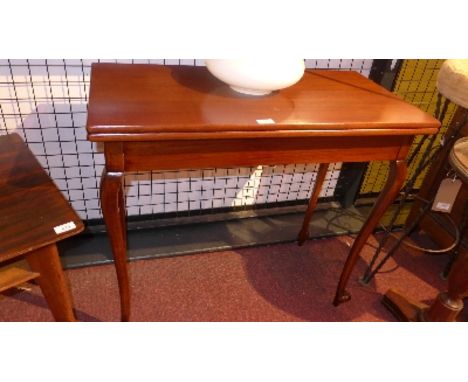 A 19th Century mahogany card table raised on cabriole legs