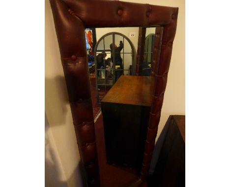 A large 20th Century mirror with brown leather button down upholstery, 187cm x 72cm