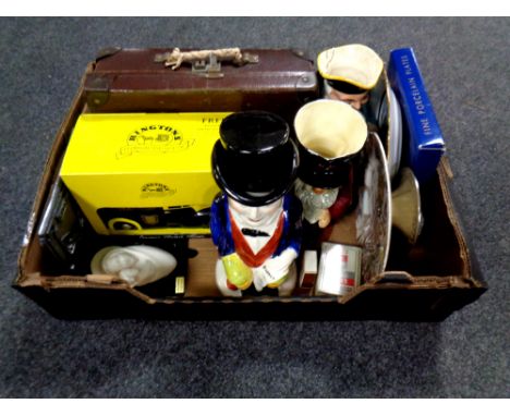 A box containing antique Toby jugs, porcelain plates, Ringtons ceramic Morris miner, miniature vintage case  