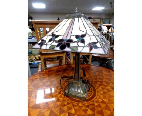 A contemporary table lamp with a leaded glass shade  