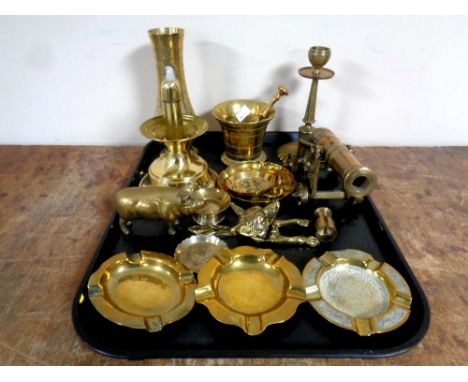 A tray containing assorted brass ware to include canon pestle and mortar, pig ornament, fox head door knocker, ashtrays etc  