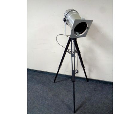 An industrial style floor lamp on tripod base 