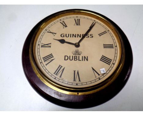 A battery operated wall clock bearing Guinness advertisement  