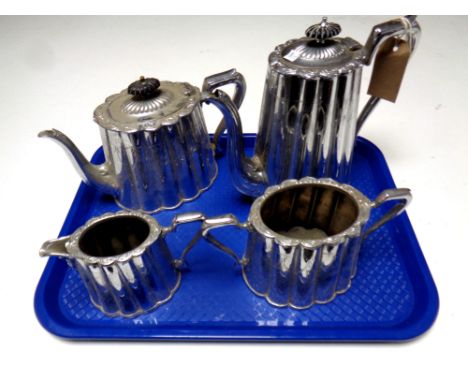 A tray containing a four piece plated tea and coffee service  