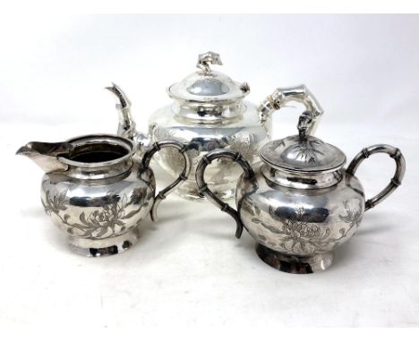 A Chinese silver plated three-piece tea service, with bamboo effect handles and engraved foliate decoration, teapot 13.5cm hi