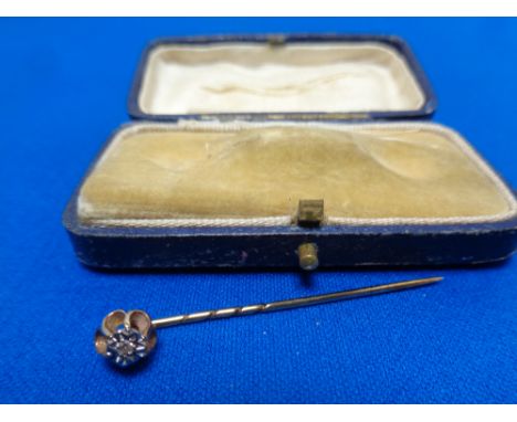 A 9ct gold diamond set stick pin 