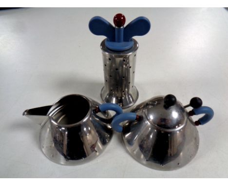 An Alessi Inox 18-10 Art Deco style cream jug and sugar basin with spoon together with matching pepper mill  