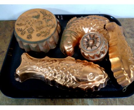 A tray containing five vintage copper jelly moulds 