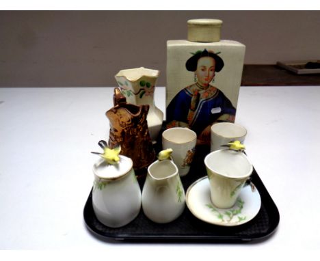 A tray containing assorted ceramics to include a Graff four piece tea service, two commemorative mugs, copper lustre jug, Mal