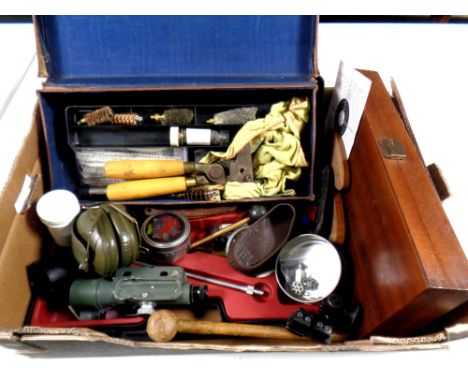 A box containing gun equipment to include tools, ear muffs, air rifle pellets, scope, leather rifle butt covers, ear defender