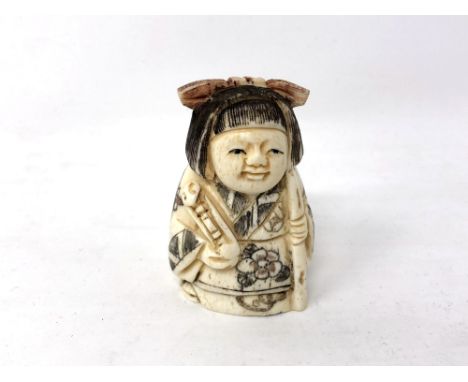 A Chinese carved bone netsuke - young girl in robes 
