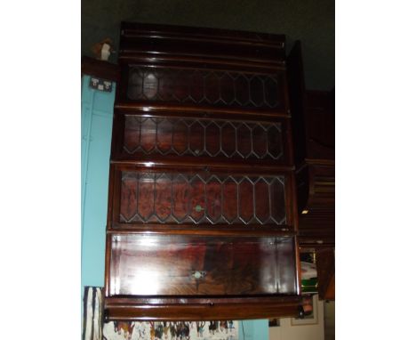 Globe-Wernicke mahogany sectional bookcase, four leaded light sections above a base drawer, each with original Globe-Wernicke